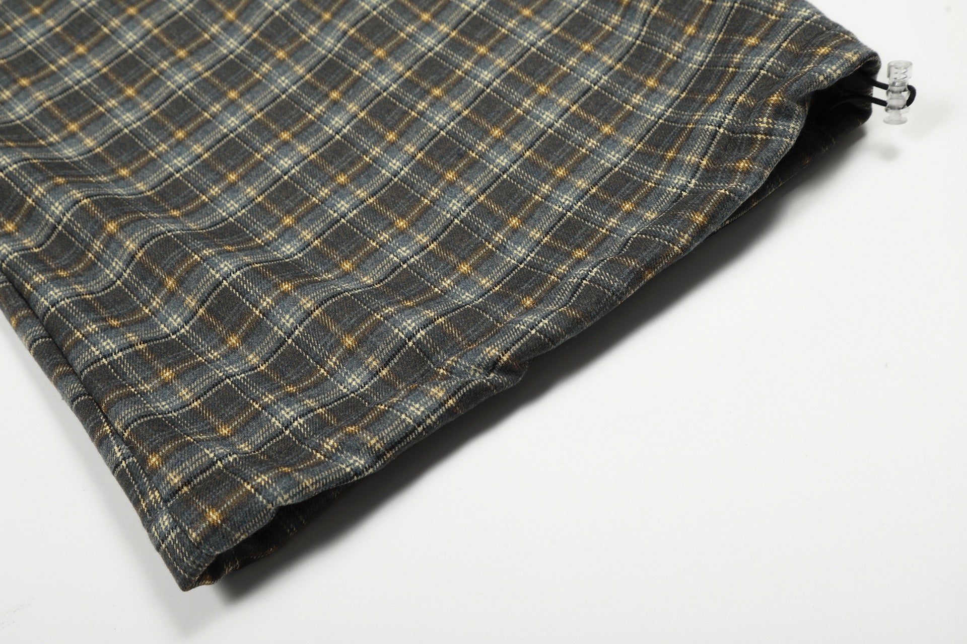 Plaid Trousers Relaxed-fit checkered pants with a brown elastic waistband