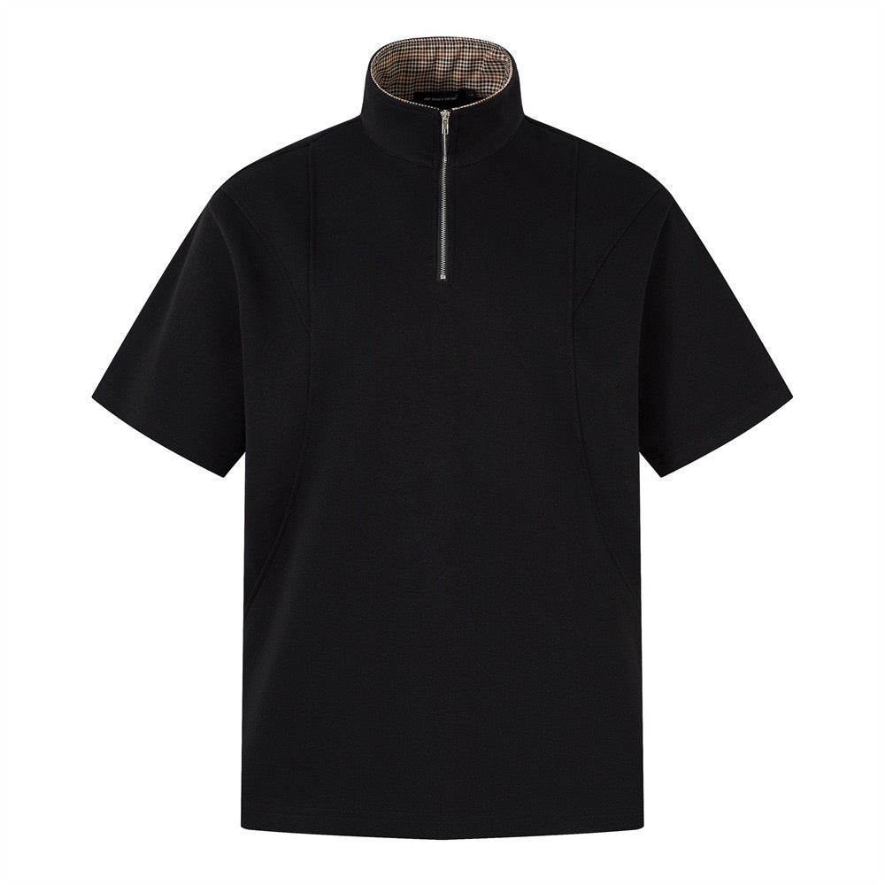 Short-sleeved black half-zip polo shirt with check-patterned collar.